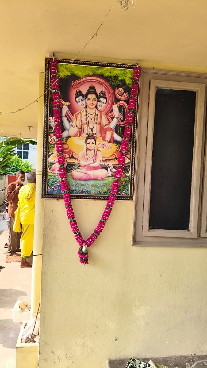 Garlanded image of Dattatreya at the family home